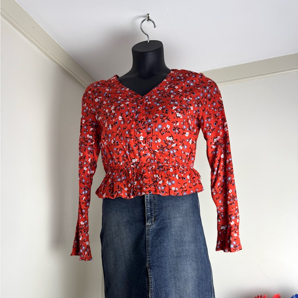 Orange top with blue and white floral motif.